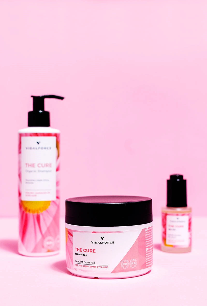 Gama VIDALFORCE THE CURE: botella, tarro de mascarilla y frasco sobre fondo rosa